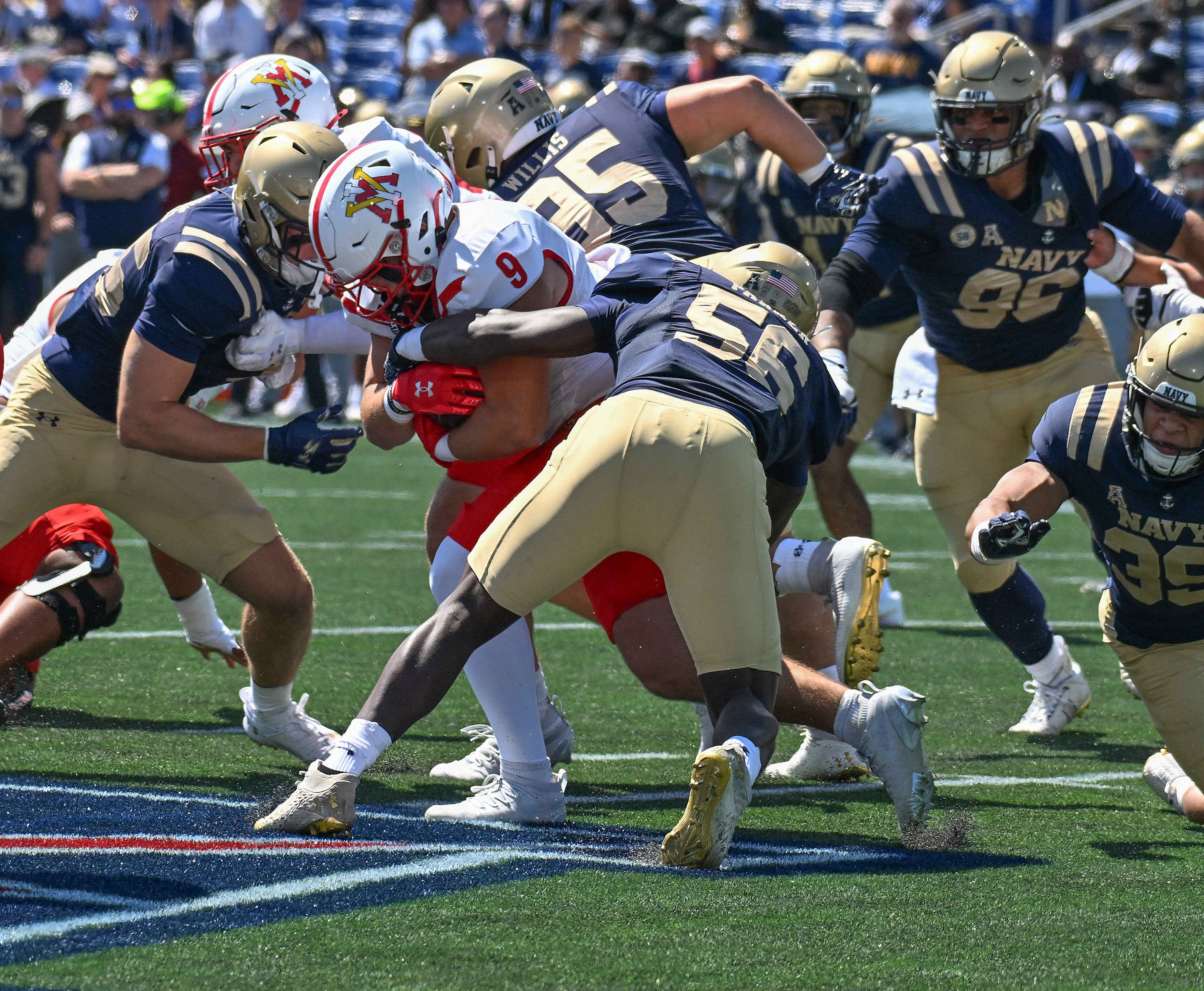 VMI's Leo Boehling is stopped on the run by Navy's MarcAnthony Parker after a gain of two yards in the first quarter. The Navy Midshipmen play their NCAA football season opener at home against the visiting VMI Keydets at Navy-Marine Corps Memorial Stadium in Annapolis. (Paul W. Gillespie/Staff)