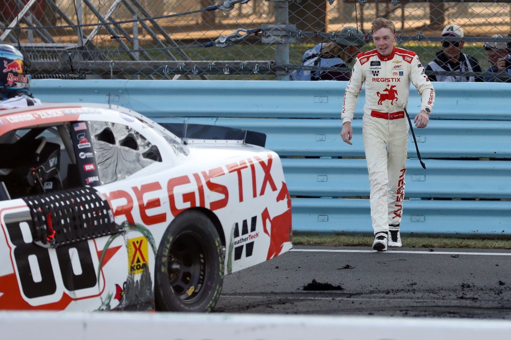 Connor Zilisch walks back to his car after winning the Mission 200 at The Glen at Watkins Glen International. Later in his celebration, he broke his collarbone after falling out of his car.