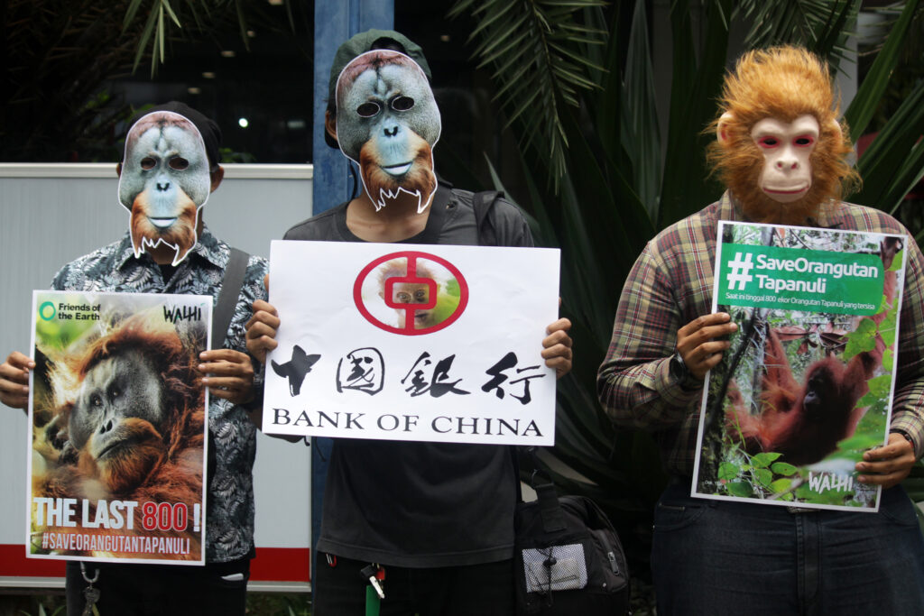 Environmental activists with WALHI and Friends of the Earth wear orangutan masks during a demonstration against the Bank of China in Jakarta on March 1, 2019. Credit: Aditya Irawan/NurPhoto via Getty Images