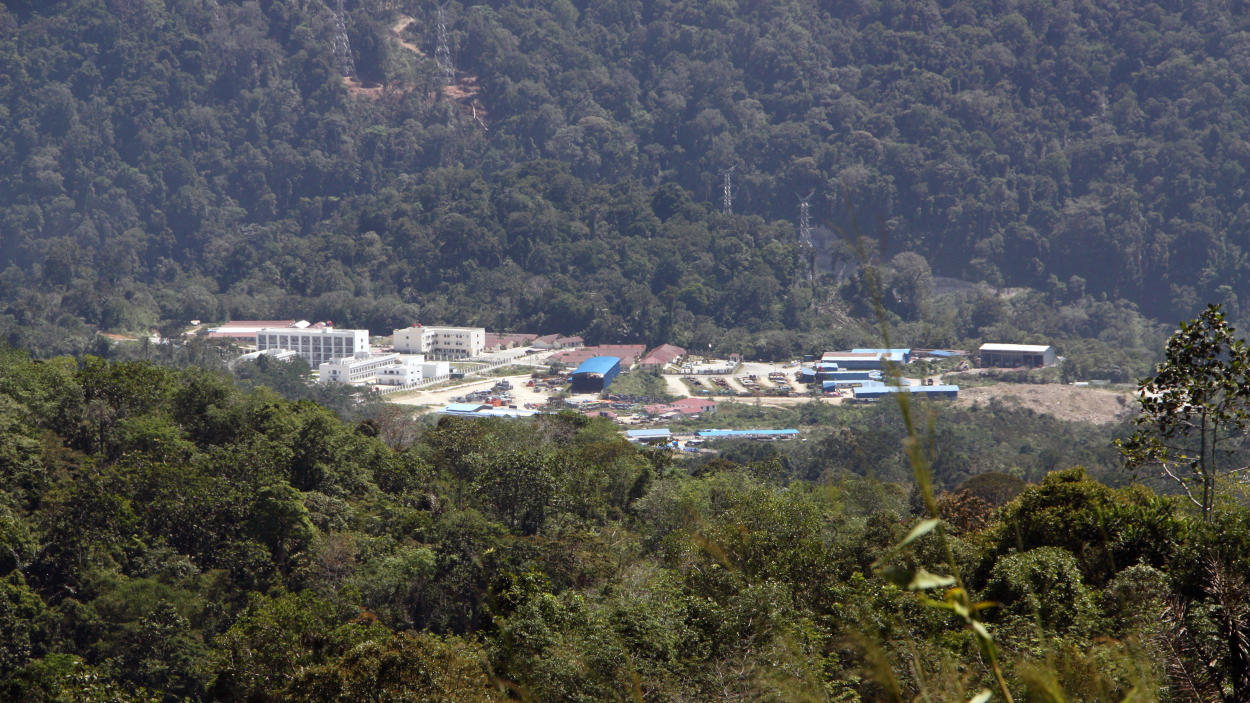 The Batang Toru dam in Sumatra is owned, financed and being built by Chinese state-owned firms. The main campus for the construction site lies behind heavily guarded gates in a remote gorge. Credit: Nicholas Kusnetz/Inside Climate News