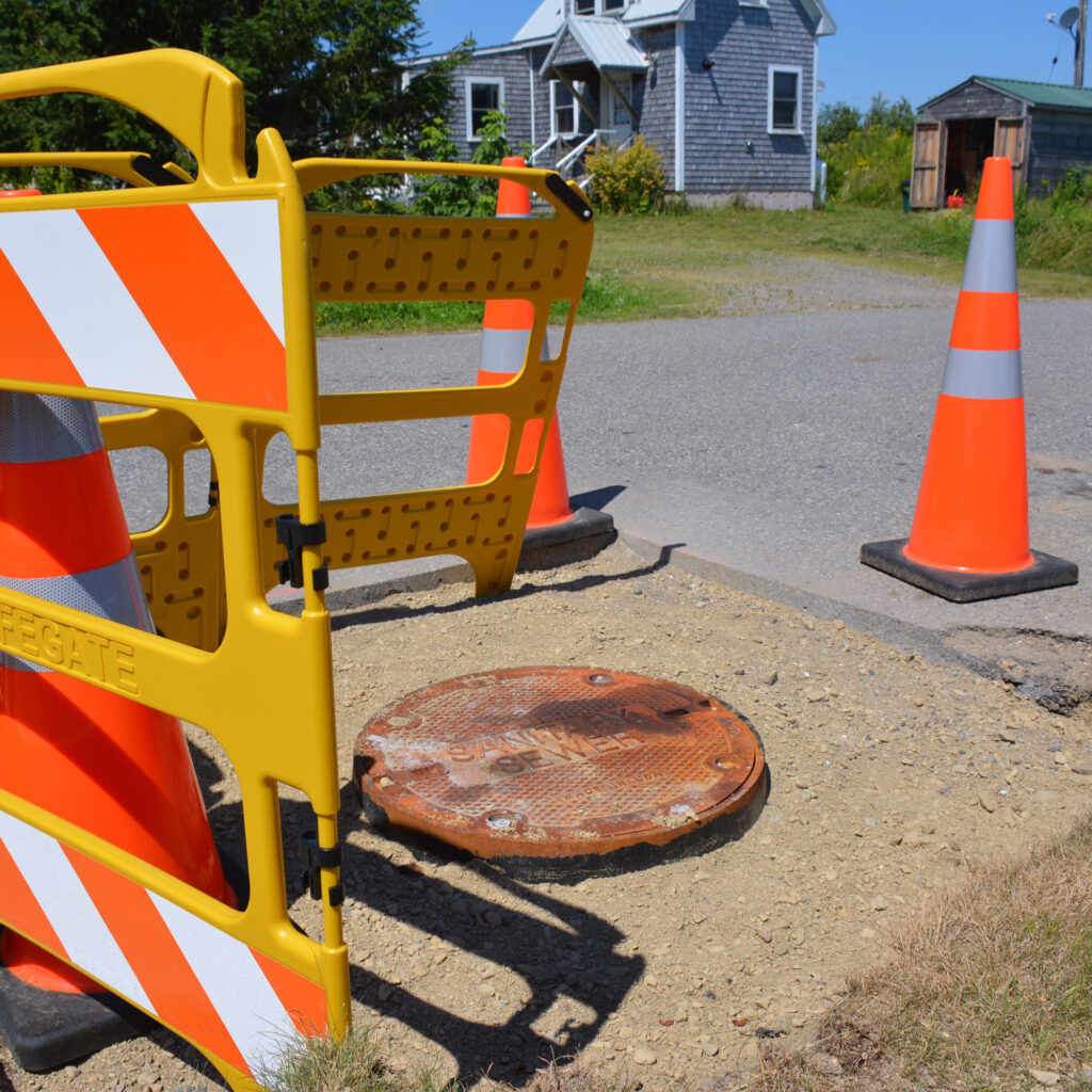 The tribal government at Sipayik is in the midst of replacing eight sewer manhole covers with water-tight covers. These manholes are in the existing floodplain. Credit: Sydney Cromwell/Inside Climate News