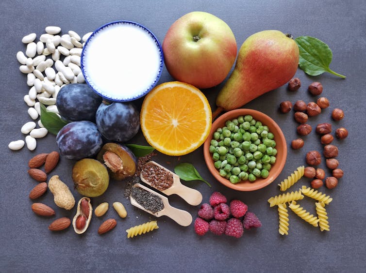 A selection of different types of food laid out against a grey surface