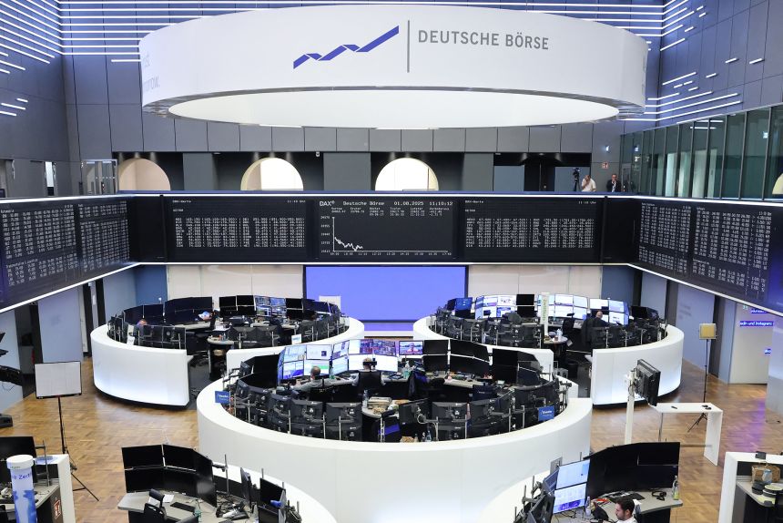 Traders work in the stock exchange in Frankfurt, Germany, on August 1.