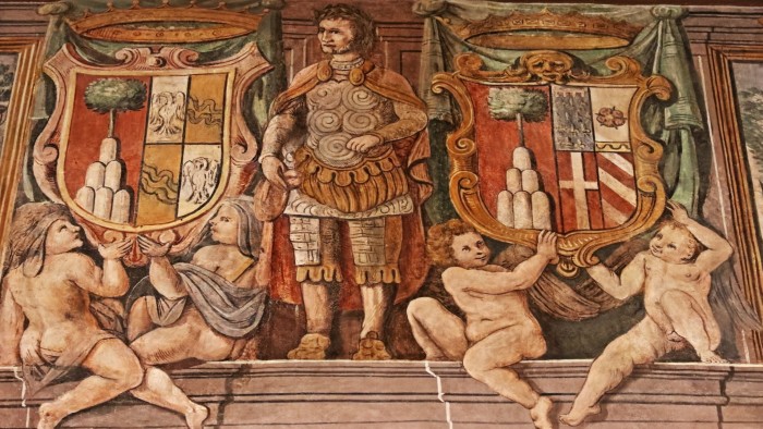 Fresco from Palazzo Cesi in Rome depicting a classical armoured figure flanked by two large heraldic coats of arms, held aloft by cherubs