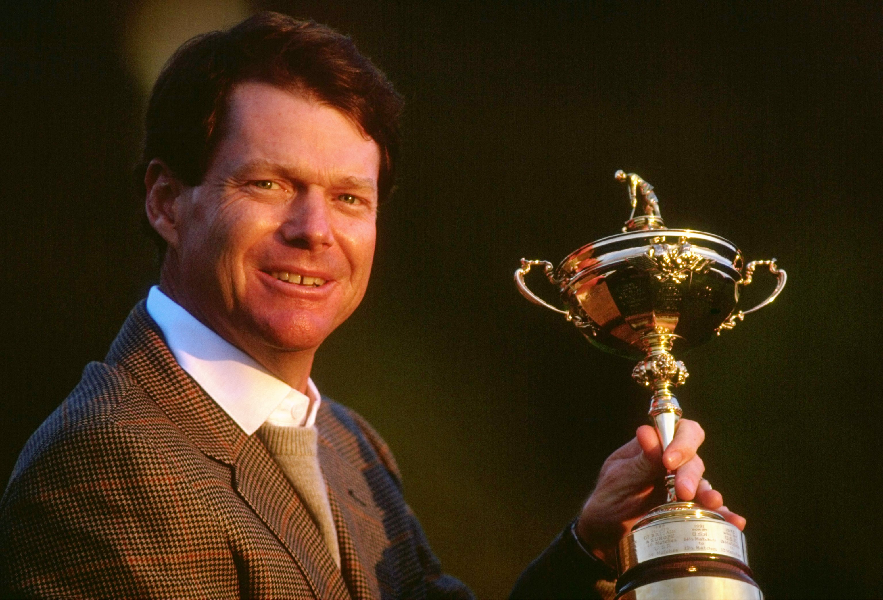 Tom Watson holding the Ryder Cup trophy.