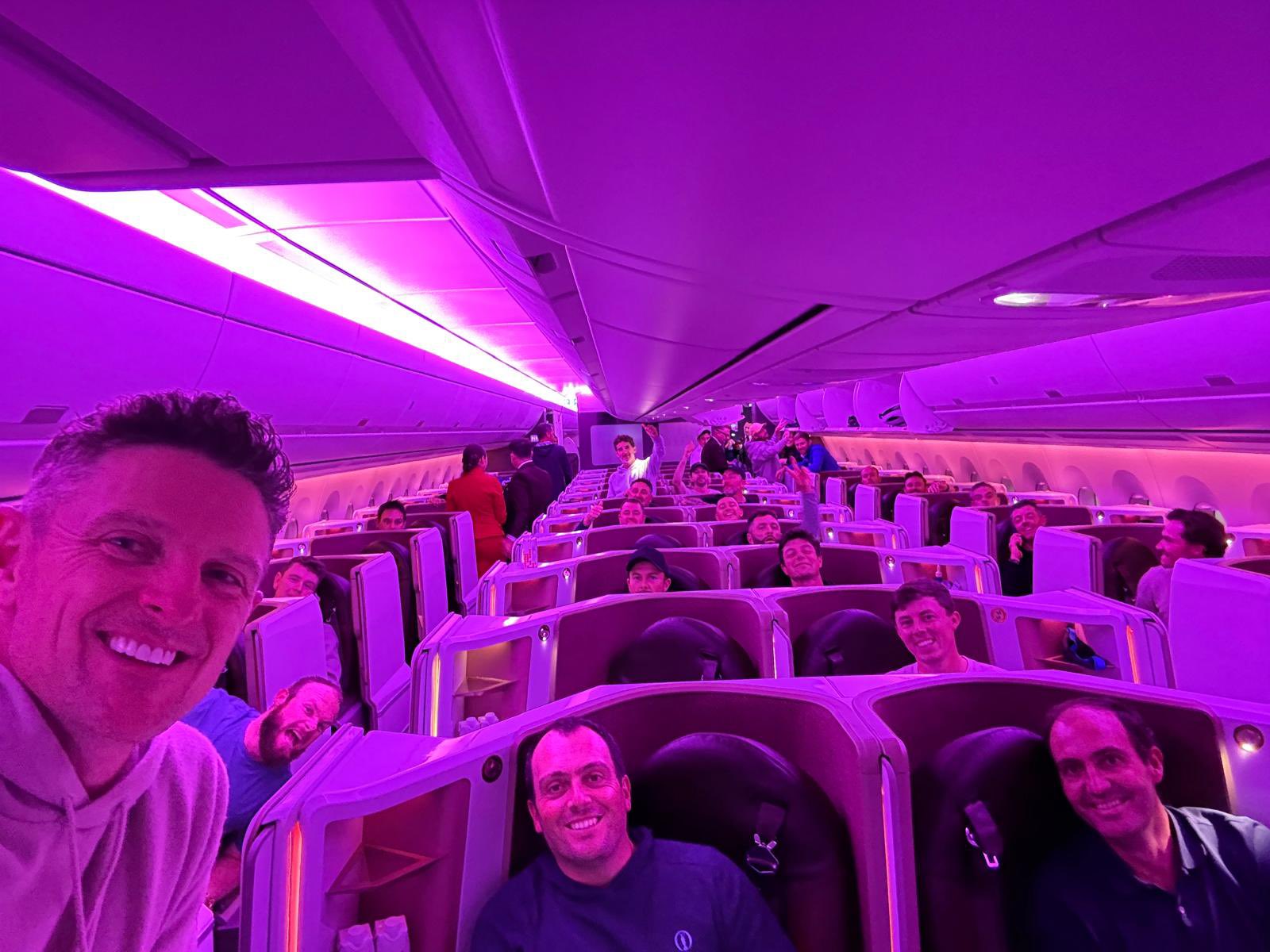 Group of people smiling on a plane.