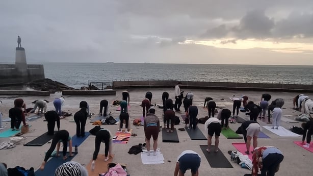 People take a yoga class as the sun rises