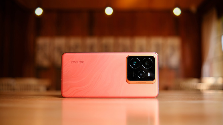 Realme GT 7 Pro in Mars Orange place horizontally showcasing rear camera