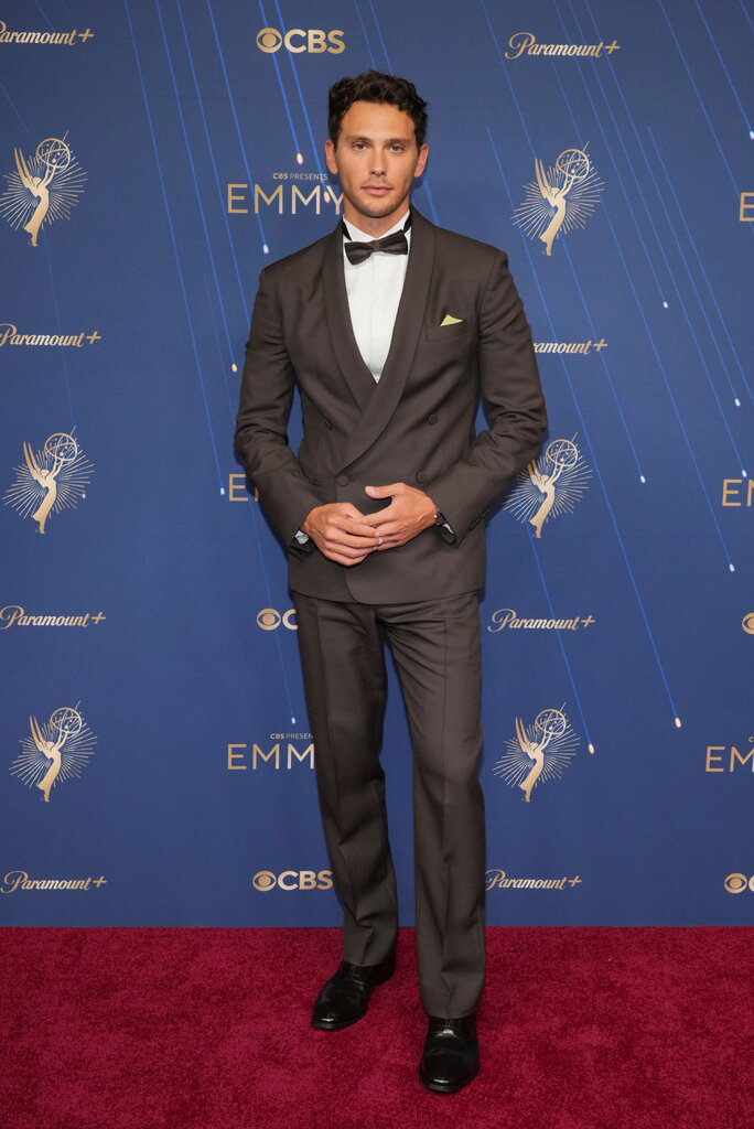 A man wears a brown suit.