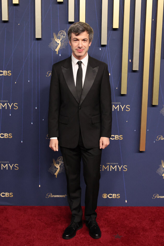 A man is wearing a black suit.