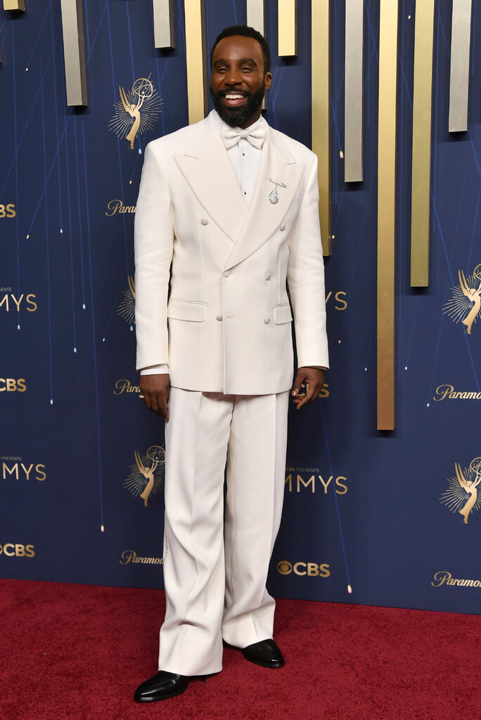 A man wears a white double-breasted tuxedo.