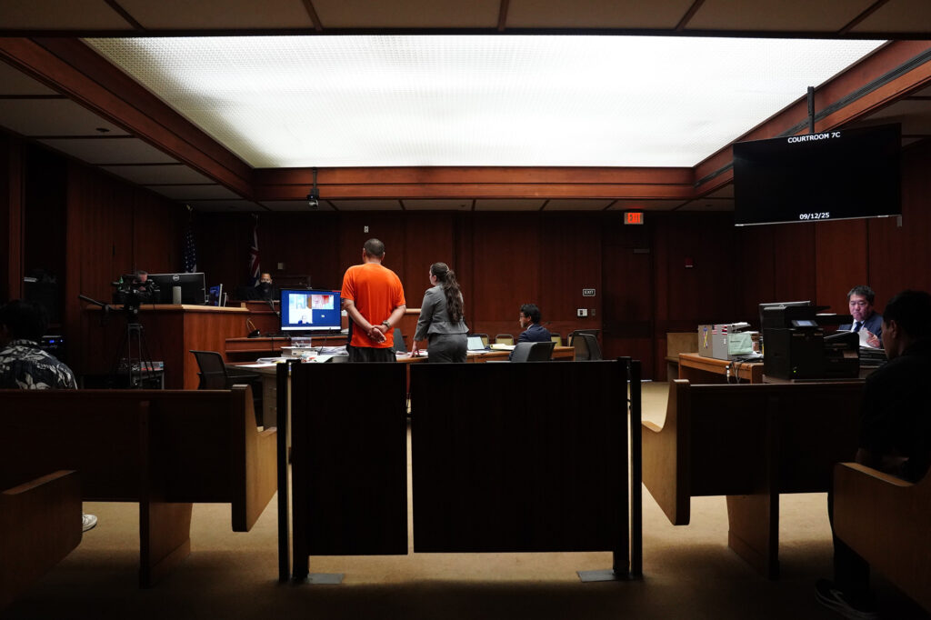 Jonathan Desoto, wearing orange, appears in court for his case Friday, Sept. 12, 2025, in Honolulu. (Kevin Fujii/Civil Beat/2025)