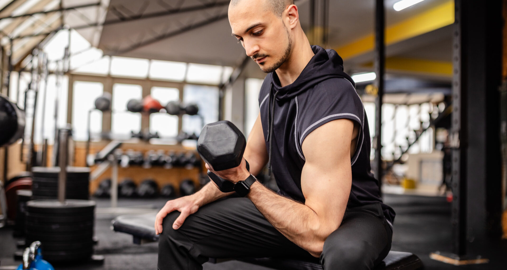 A man performing a concentration bicep curl