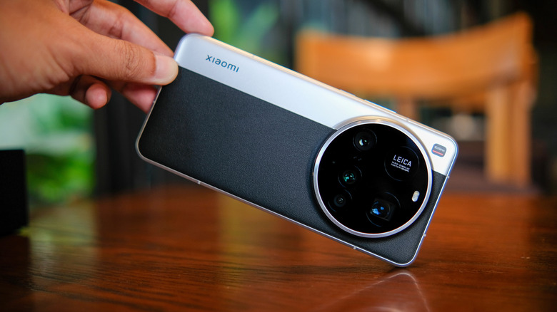 A man holding Xiaomi 15 Ultra showcasing rear camera design