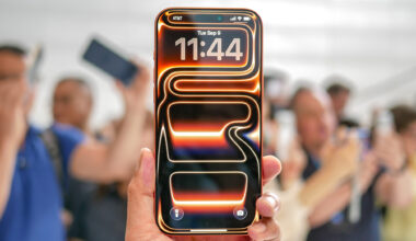 An orange Apple iPhone 17 Pro Max with its default neon wallpaper