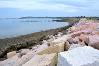 A wall made of boulders protects portions of Sipayik’s eastern coast from tidal erosion in Maine. Credit: Sydney Cromwell/Inside Climate News