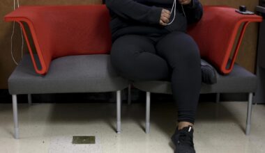 A student fidgets with pull cords on blinds