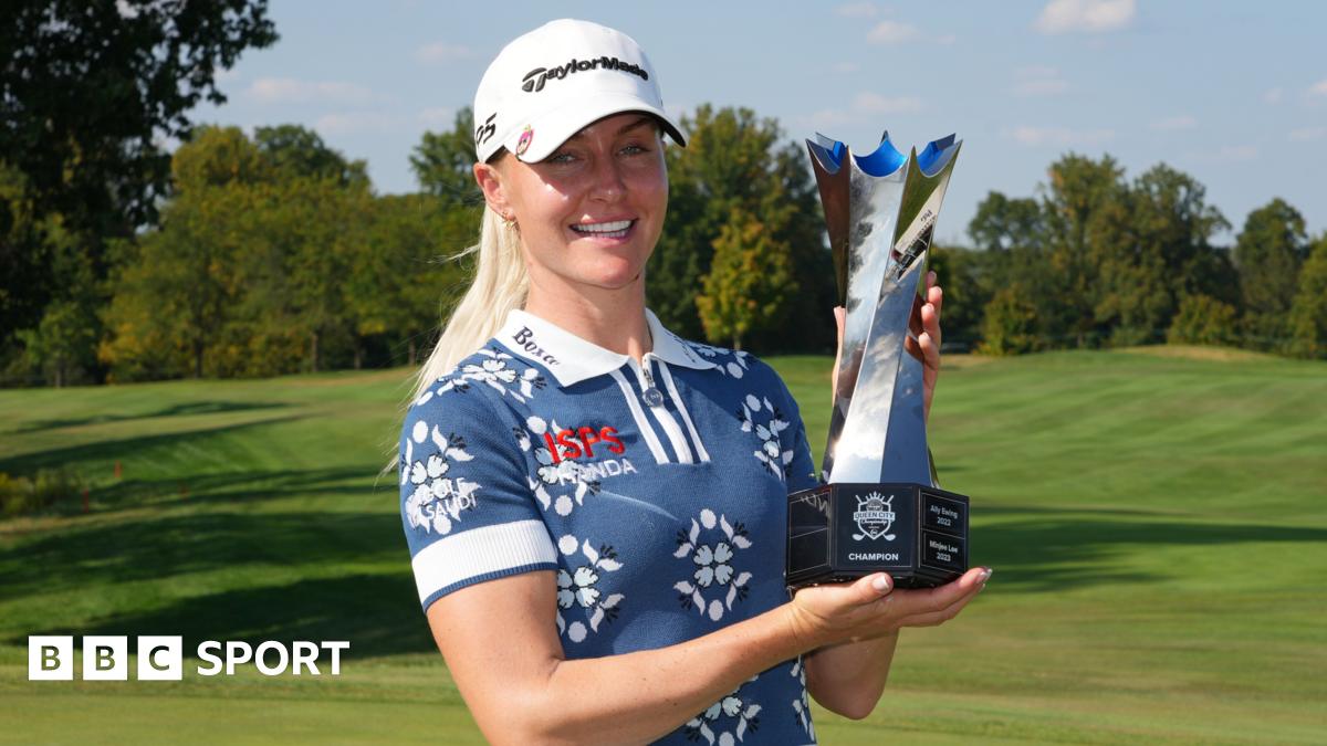English golfer Charley Hull smiles as she holds up the trophy for winning the 2025 Queen City Championship