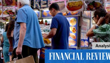 A pedestrian carries a Macy’s Inc. branded shopping bag in New York on Tuesday.