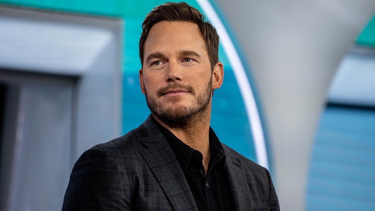 chris pratt smiles while wearing a blazer