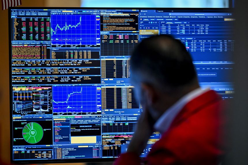 A trader works on the floor of the New York Stock Exchange during morning trading on August 13, in New York.