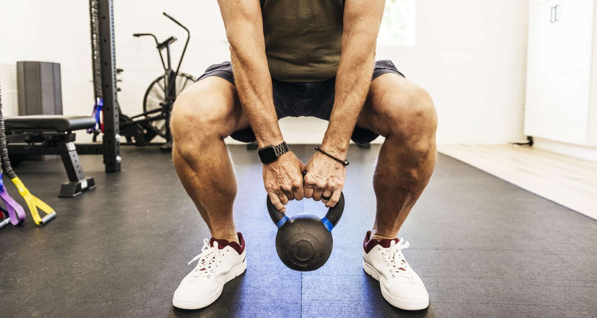 a man doing a kettlebell squat