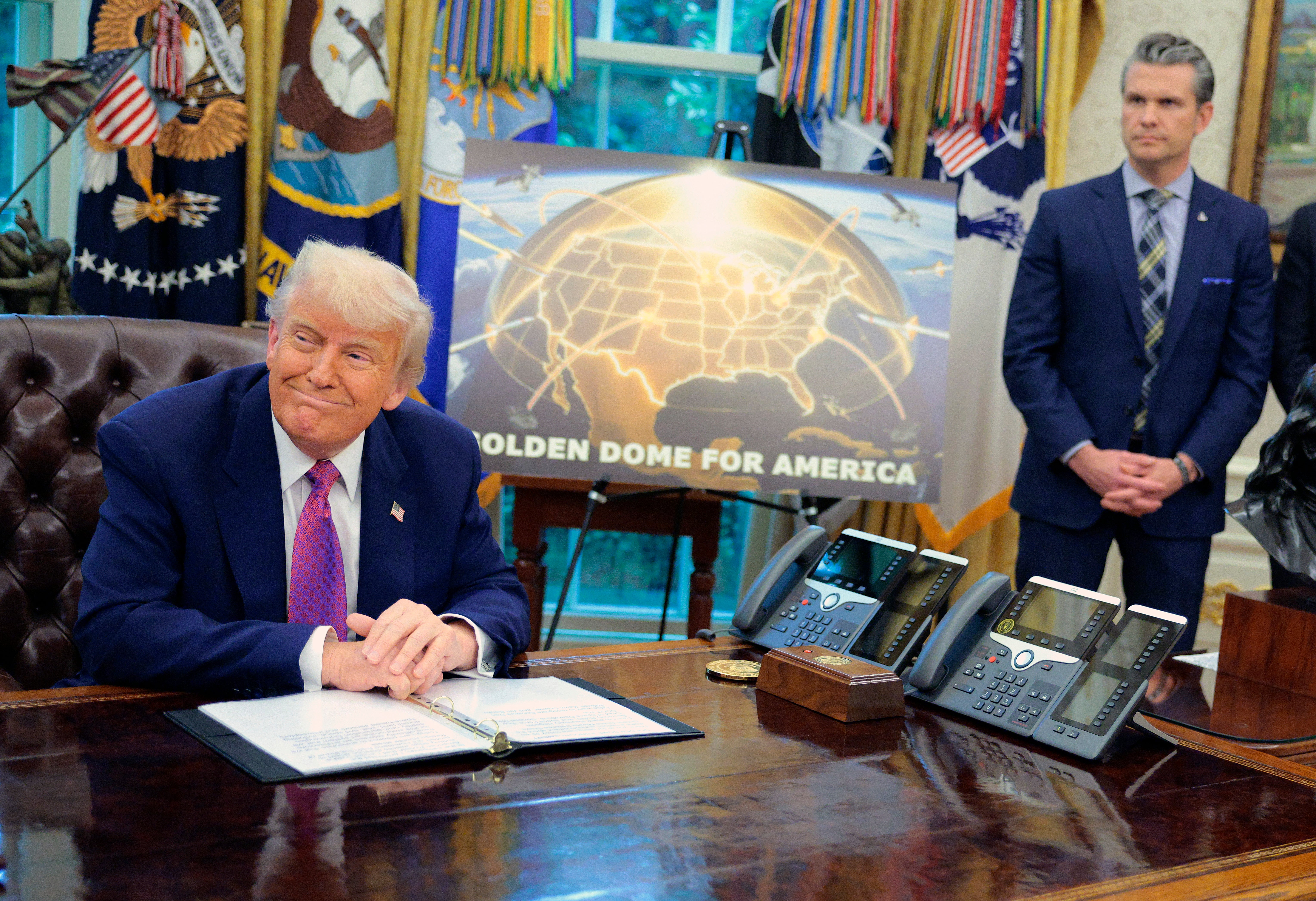 President Donald Trump and Secretary of War Pete Hegseth unveil their Golden Dome missile defense project in the Oval Office on May 20