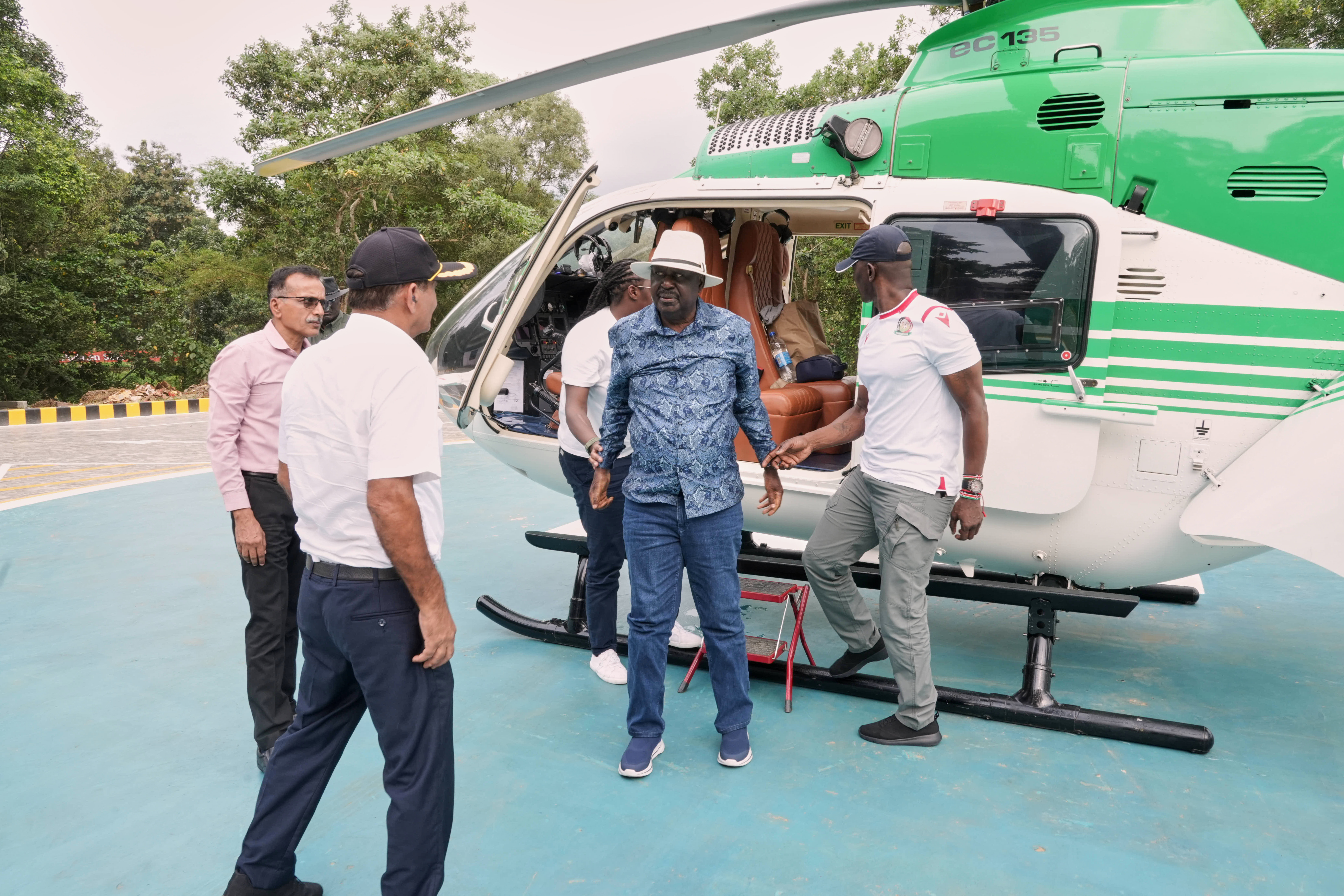 Former Kenyan Prime Minister Raila Odinga, center in blue, arrives at the Sreedhareeyam Ayurvedic hospital in Koothattukulam, Kerala, India.