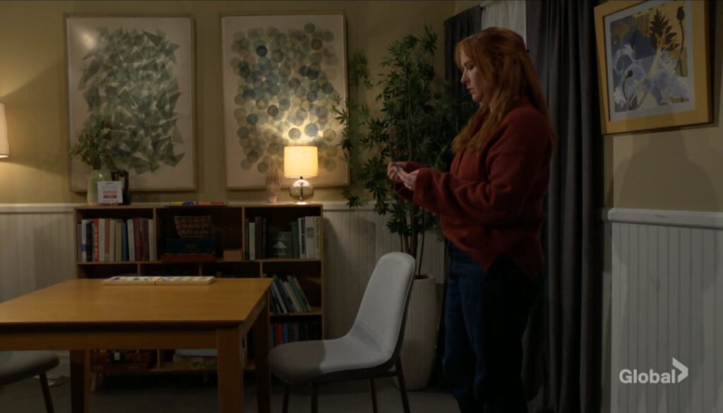 Mariah looks at the ripped card.