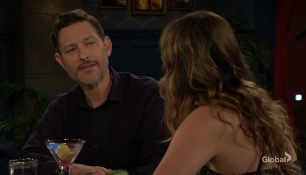 Daniel and Tessa talk at the bar.