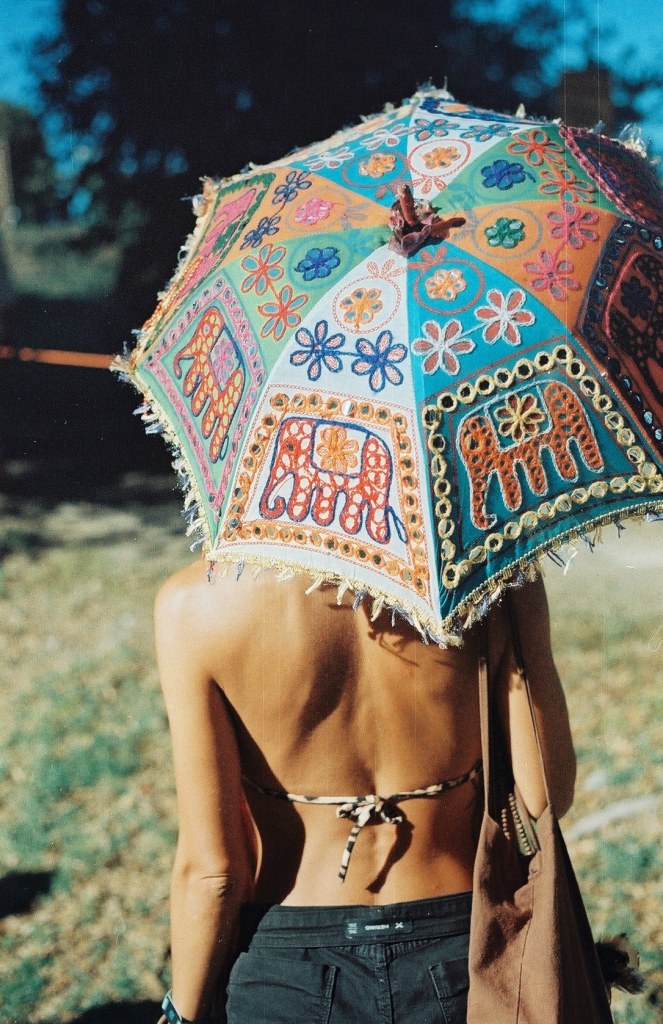Woman underneath brightly coloured umbrella (Courtesy Lomography)