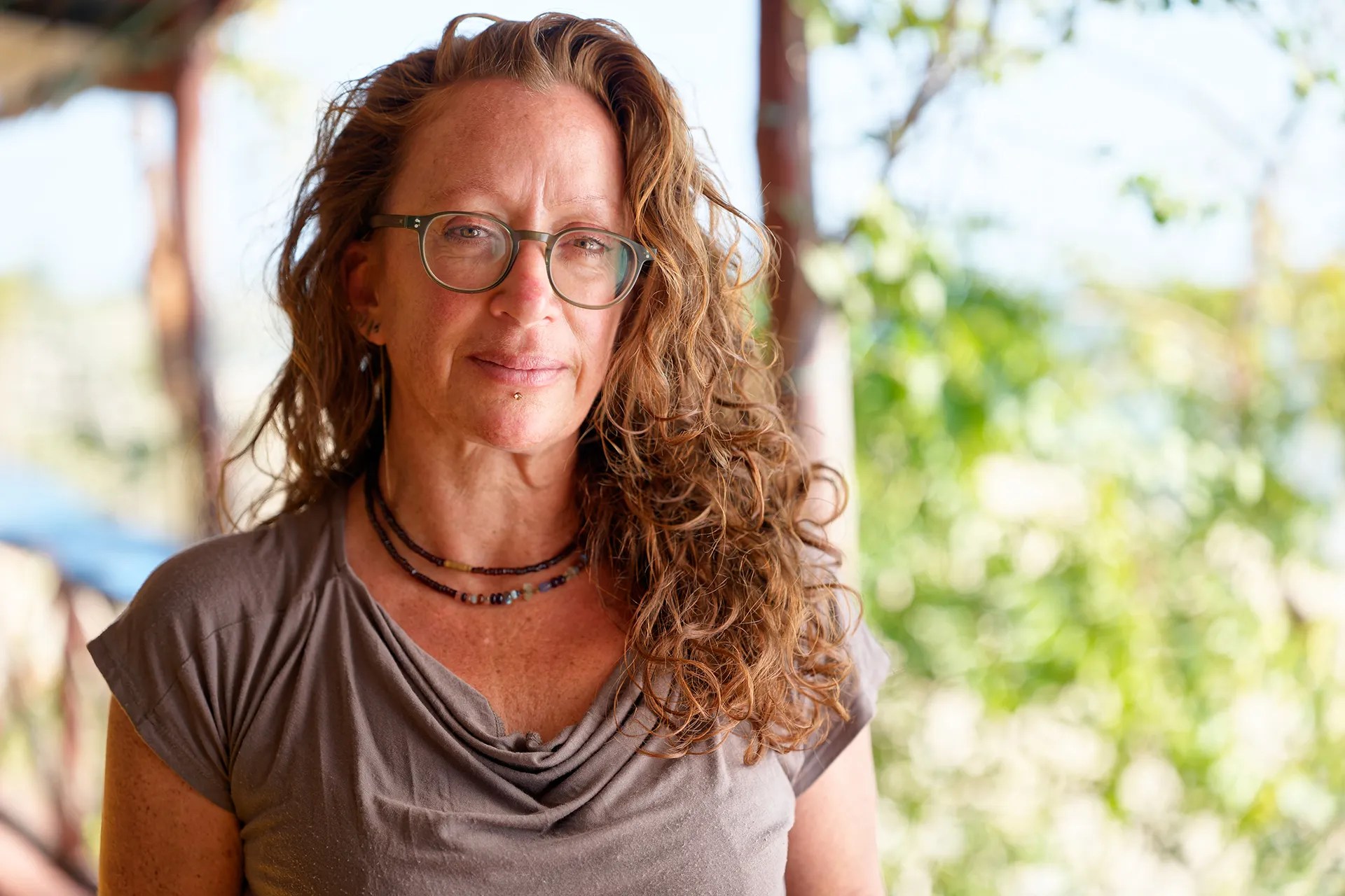 A white woman with curly brown hair.