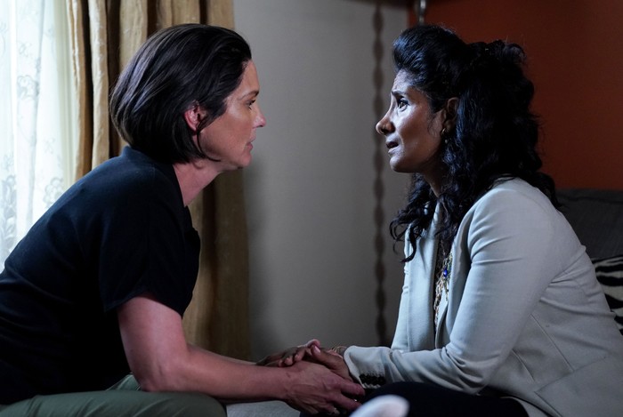 Eve and Suki holding hands as they talk in EastEnders