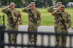 National Guard soldiers salute as President Donald Trump's motorcade drives by, Saturday, Sept. 20, 2025, in Washington. (AP Photo/Julia Demaree Nikhinson)