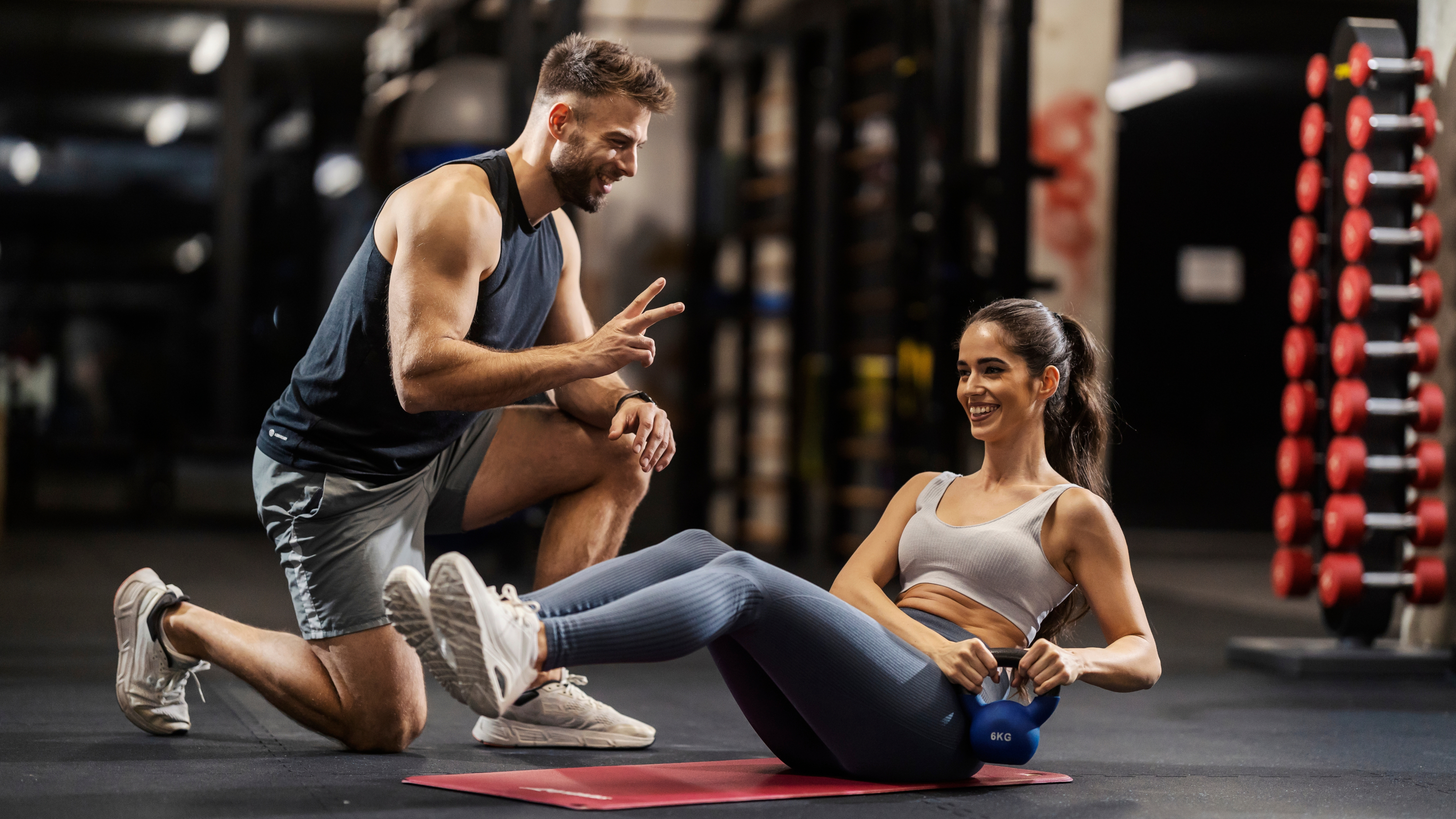 a personal trainer teaching a client
