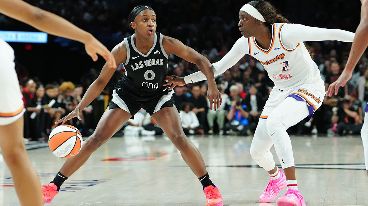Las Vegas Aces guard Jackie Young (0) dribbles against Phoenix Mercury guard Kahleah Copper (2) during the fourth quarter of game one of the 2025 WNBA Finals at Michelob Ultra Arena.