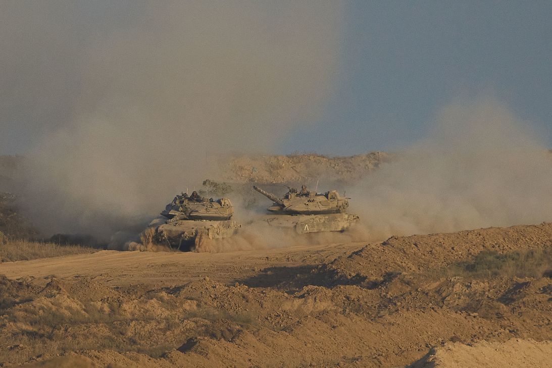Israeli soldiers drive tanks inside Gaza toward southern Israel on October 5, 2025.