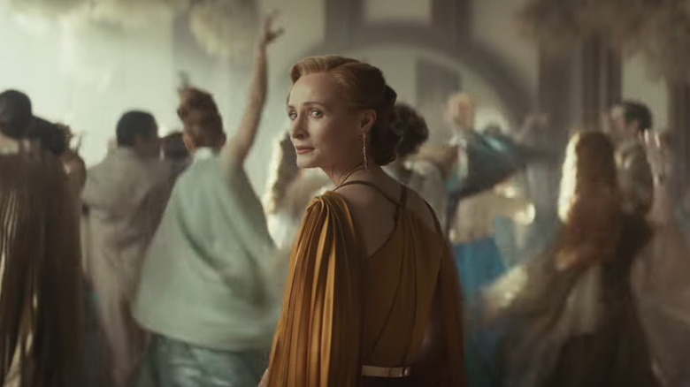 Mon Mothma surrounded by dancing wedding guests in Andor