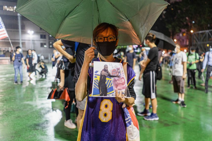 A Hong Kong protester in an LA Lakers jersey holding a LeBron James picture during a pro-democracy demonstration in October, 2019.