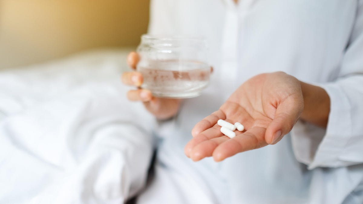 Woman taking magnesium for sleep