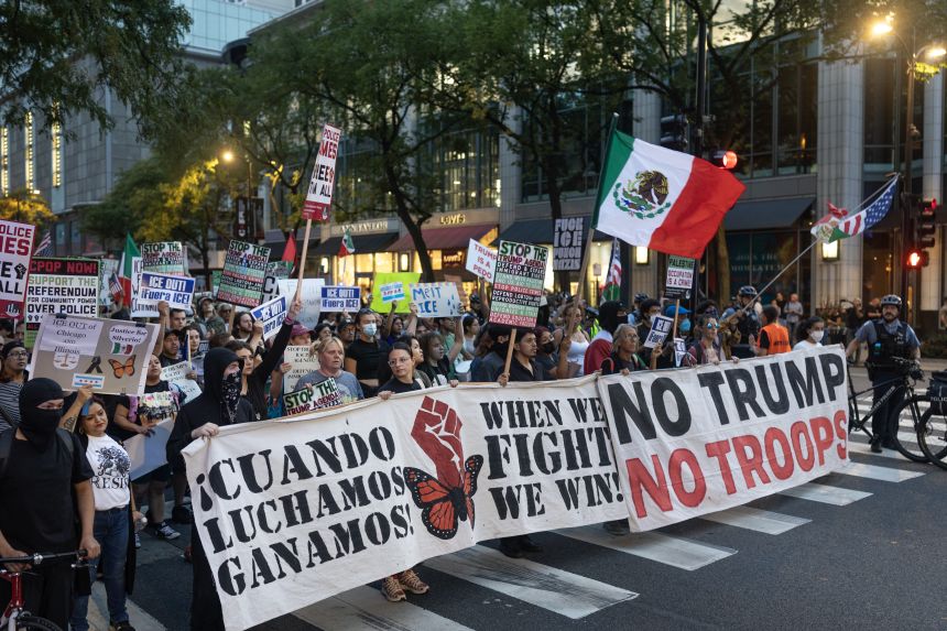 Demonstrators march along the Magnificent Mile protesting the agenda of the Trump administration on September 30.