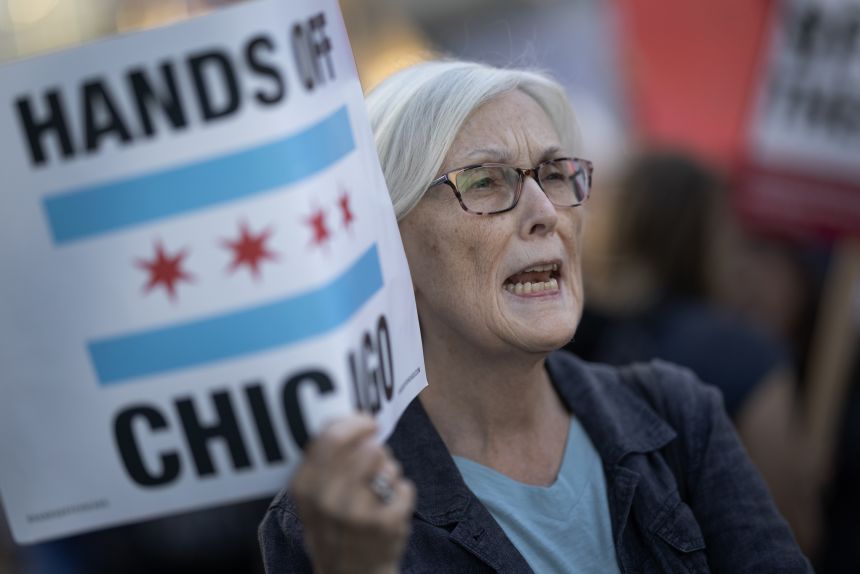 Demonstrators protest downtown in Chicago after recent ICE raids in the city.
