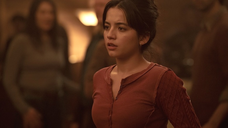 Dina watches Ellie during the Jackson commune celebrations in The Last of Us