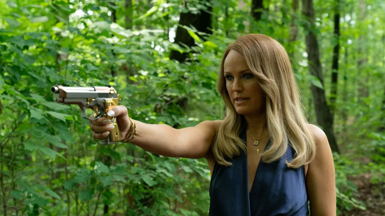 Malin Akerman as Margo Banks holding a gun in The Hunting Wives