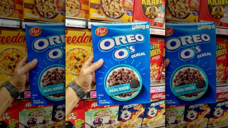 Hand holding a box or Oreo O's at the grocery store