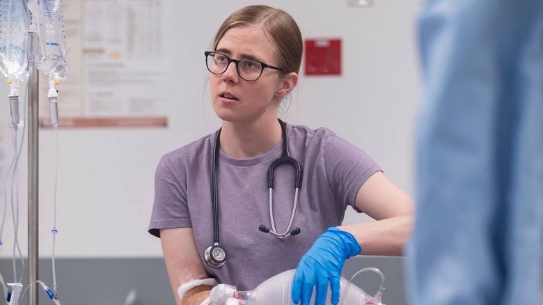Mel looking concerned and holding an Ambu bag on The Pitt