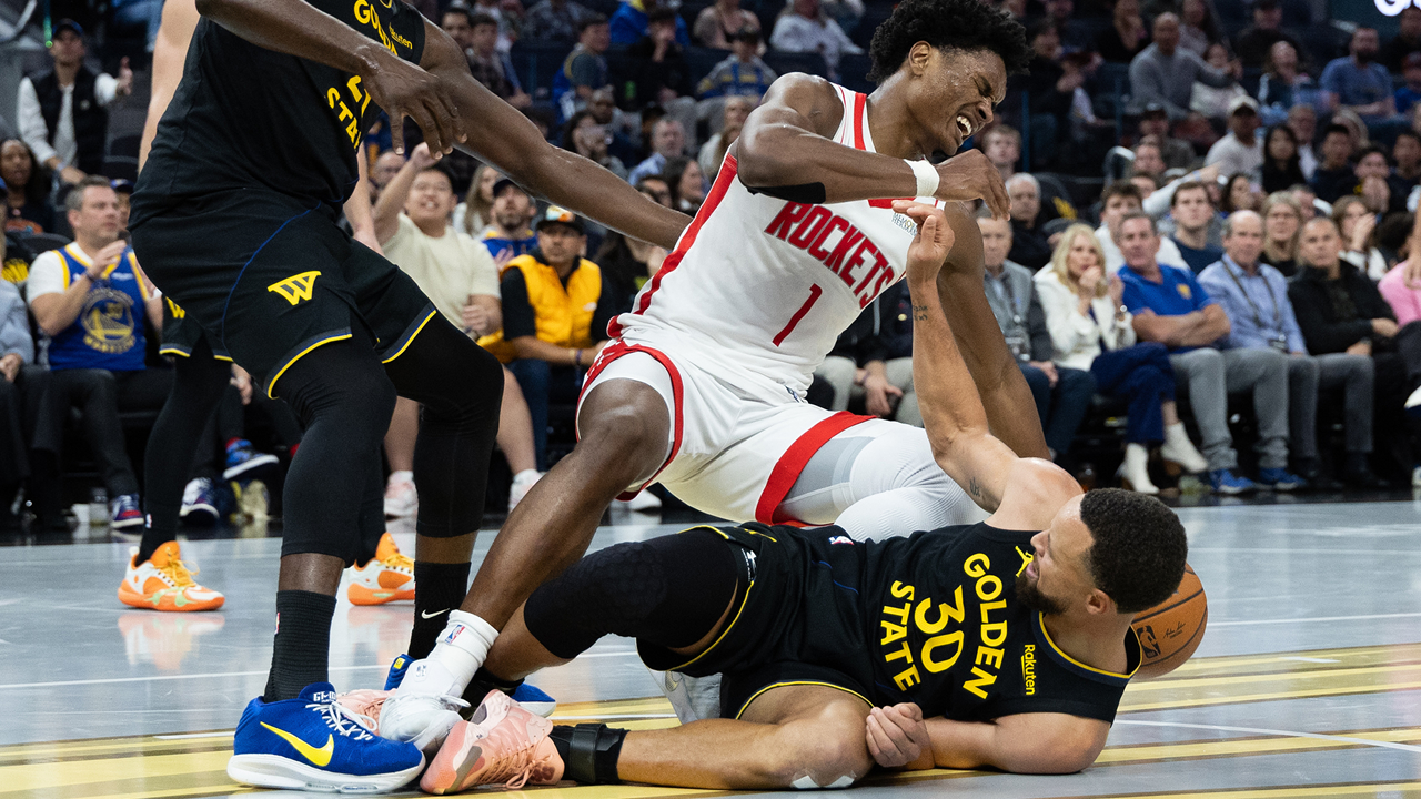 Golden State Warriors guard Stephen Curry (30) and Houston Rockets guard Amen Thompson (1) make contact during the second half of an Emirates NBA Cup basketball game Wednesday, Nov. 26, 2025, in San Francisco. 