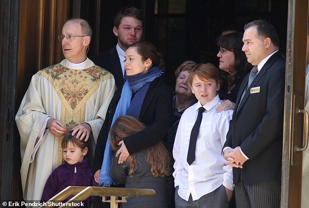 O'Donnell seen with with the former couple's children Willa, Tallulah and Cooper at his funeral in 2014