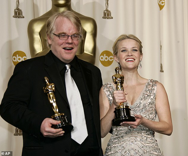 Hoffman is seen celebrating his Best Actor Oscar for Capote alongside Reese Witherspoon, who won for Walk The Line in 2006