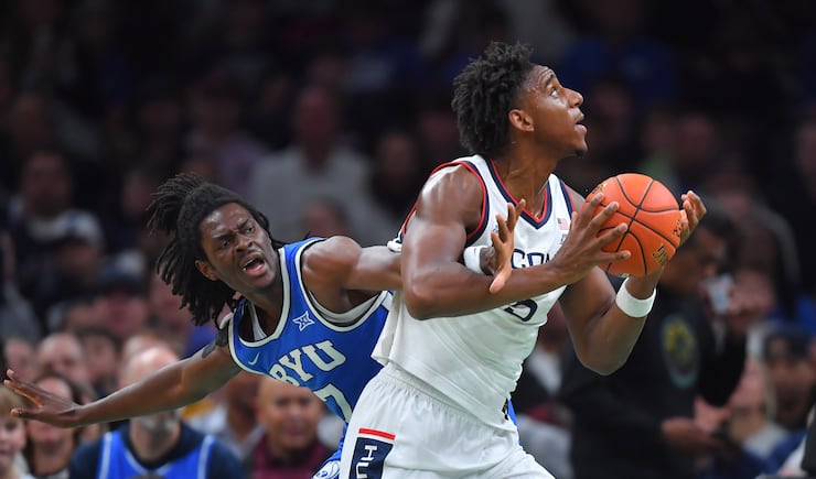 UConn forward Tarris Reed Jr., right, drives toward the basket as BYU forward Khadim Mboup defends in the first half of an NCAA college basketball game, Saturday, Nov. 15, 2025, in Boston.